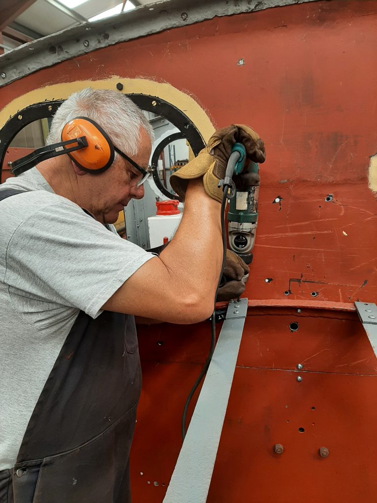 John Davis drilling holes in the new angles above Fluff's engine compartment