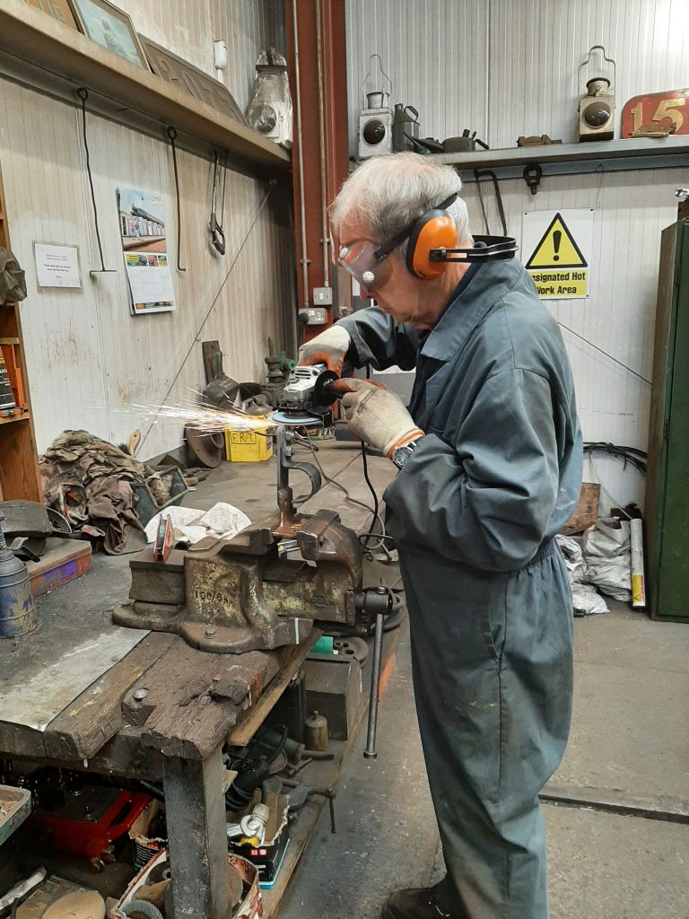 John Dixon fabricating a new vacuum pipe support bracket