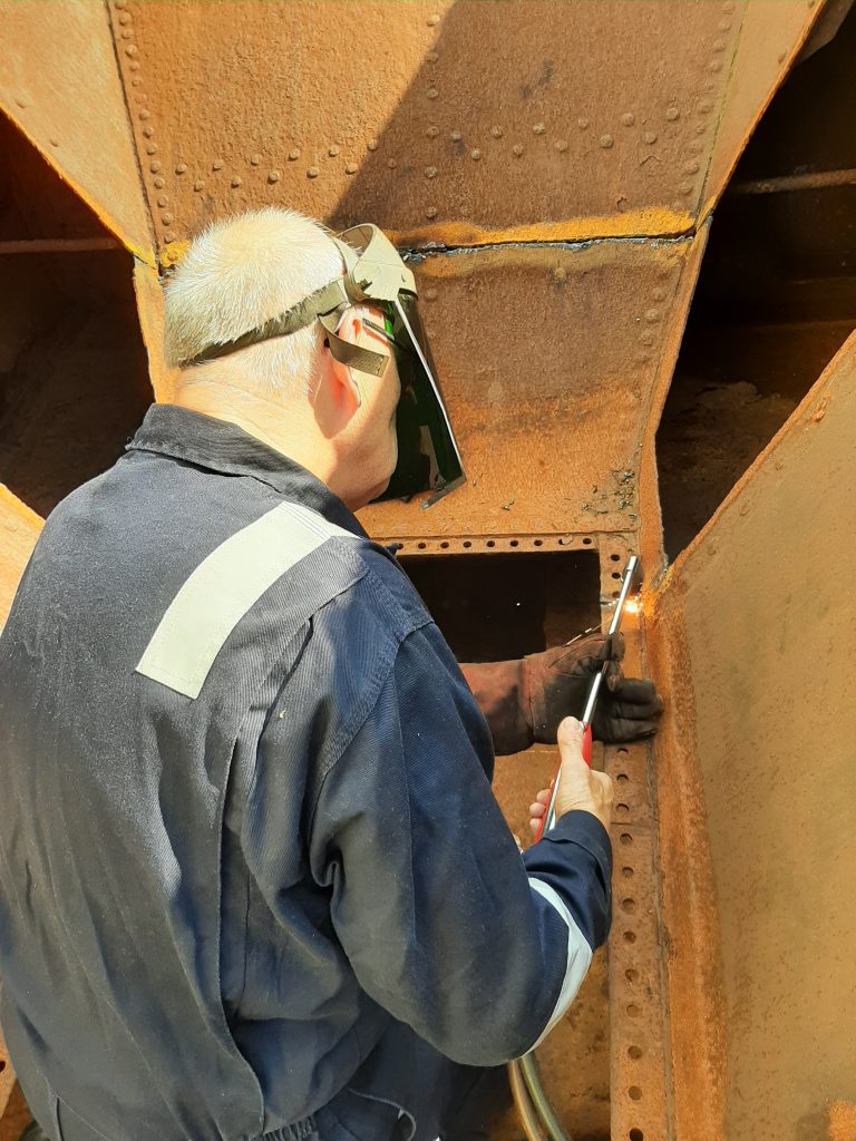 Ron Crowe cutting more steel from Wootton Hall's tender tank