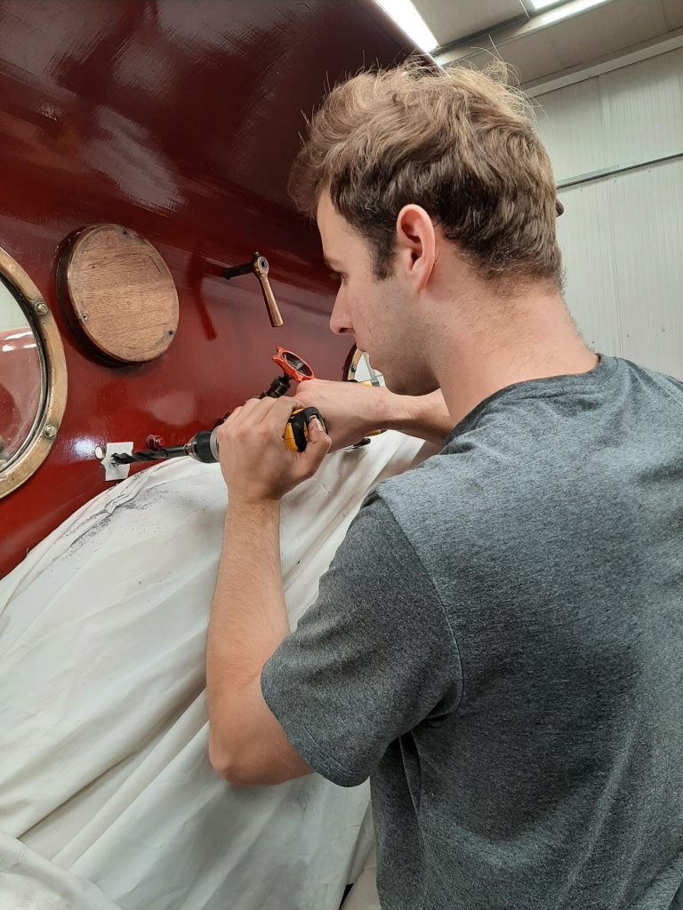 Sam drills a new hole in FR 20's cab spectacle plate