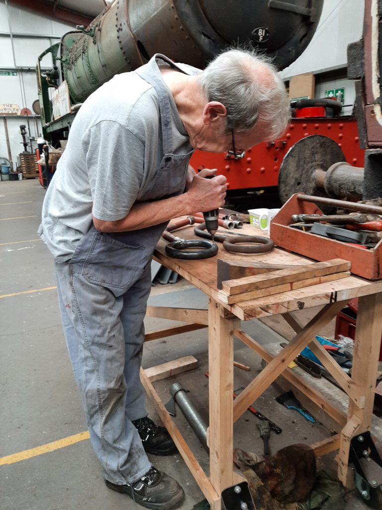 John Dixon drills new holes in the upper side of the new blower ring for FR 20