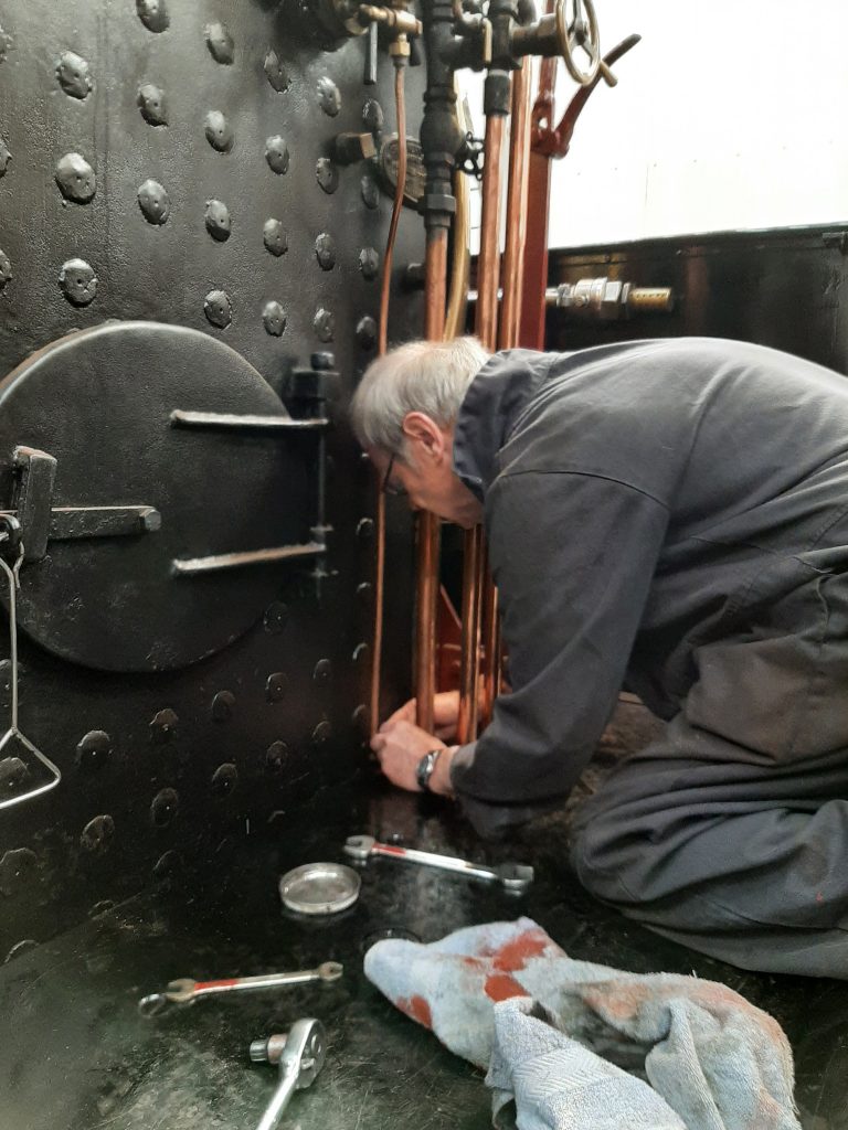 John Dixon fits retaining clamps for the water gauge drain pipes