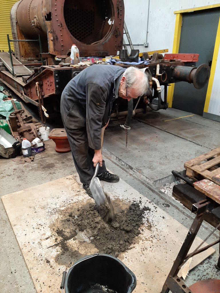 John Dixon mixes concrete for FR 20's smokebox floor