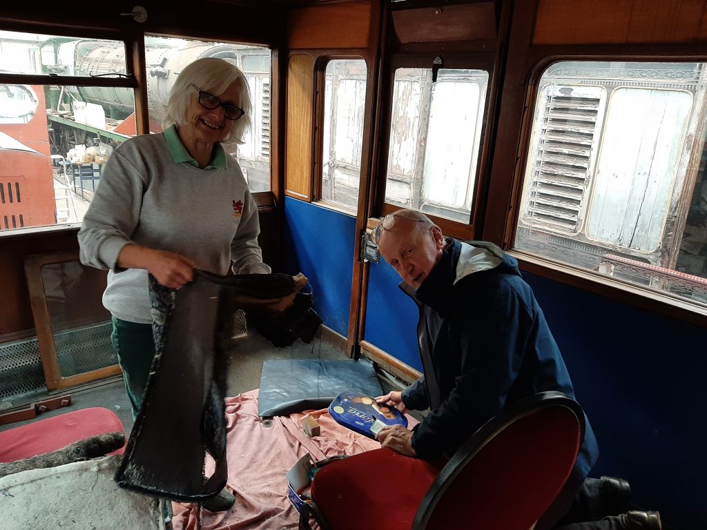 Anne and Phil Bolton working on the upholstery in GER No. 5