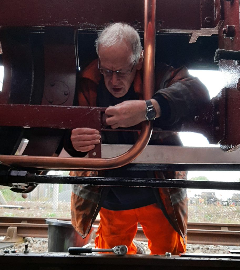 John Dixon fits a new pipe retention bracket on FR 20's frames