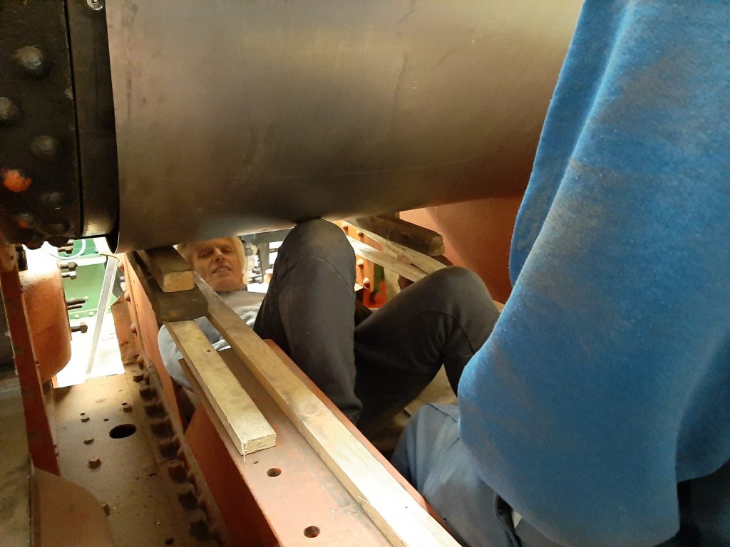 Ed having a knees up under Wootton Hall's boiler