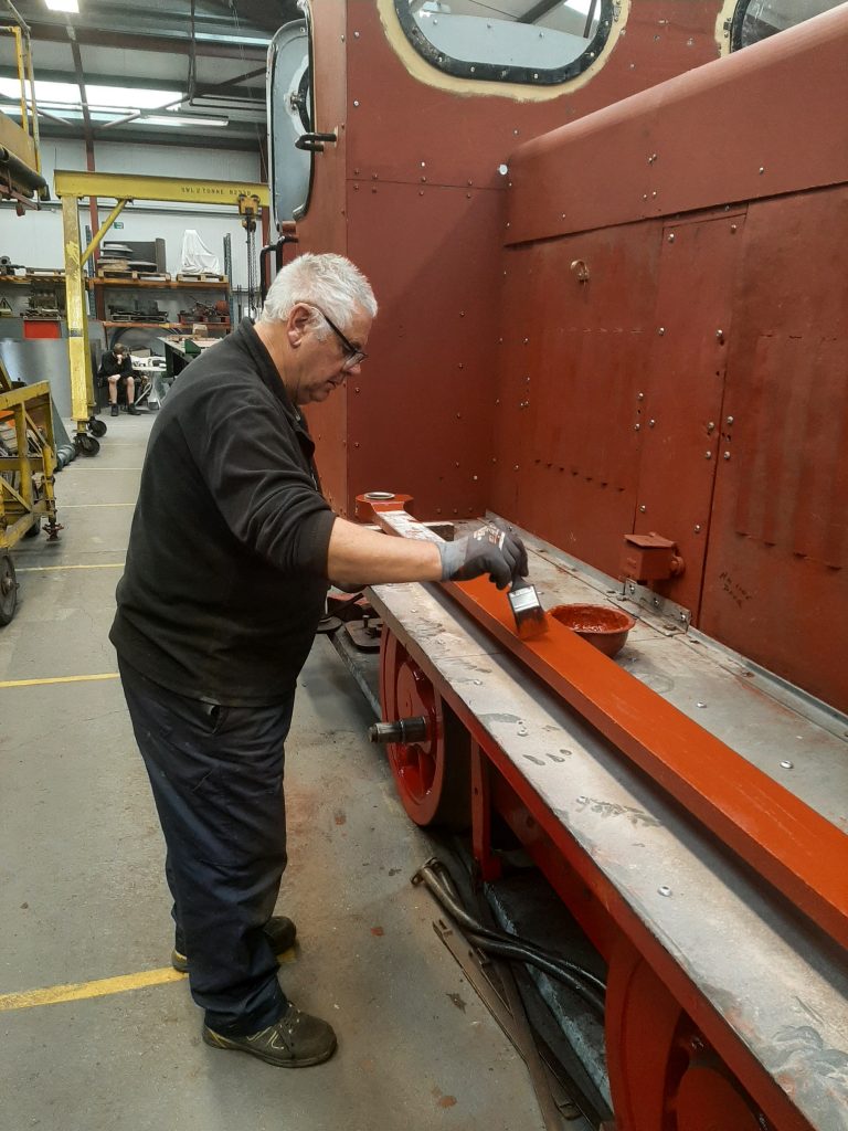 John Davis painting one of Fluff's rods