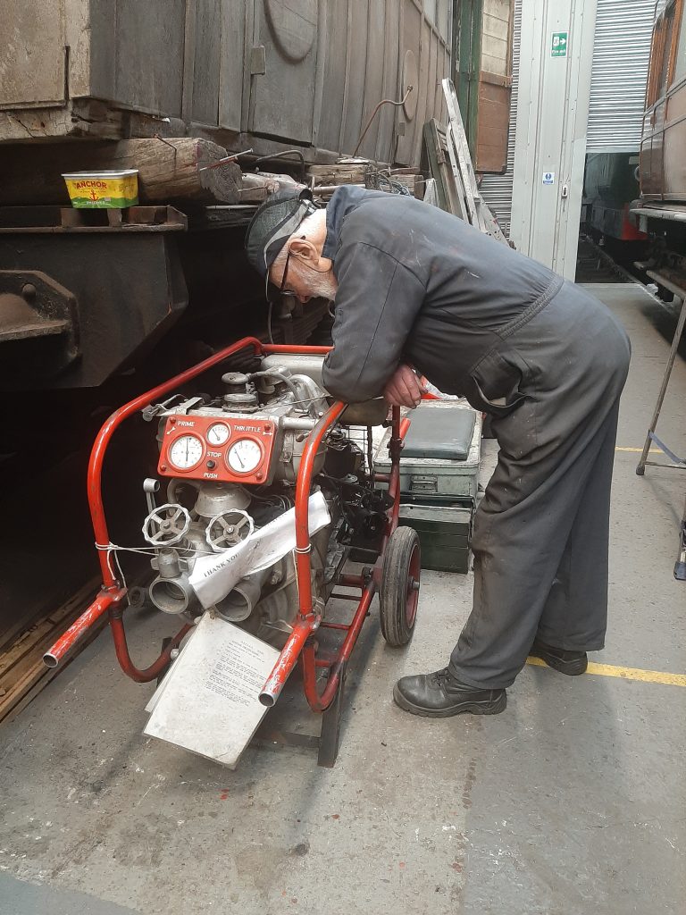 Roger Benbow examining the fire pump