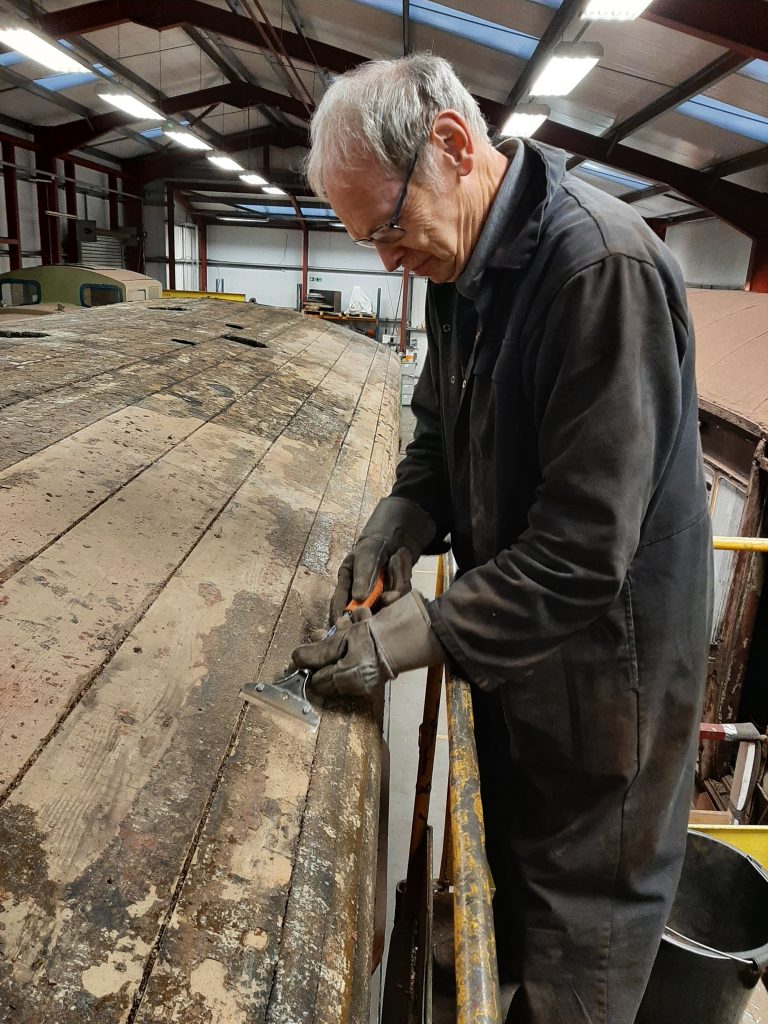 John Dixon chips away at the roof bonding compound on GER No. 5