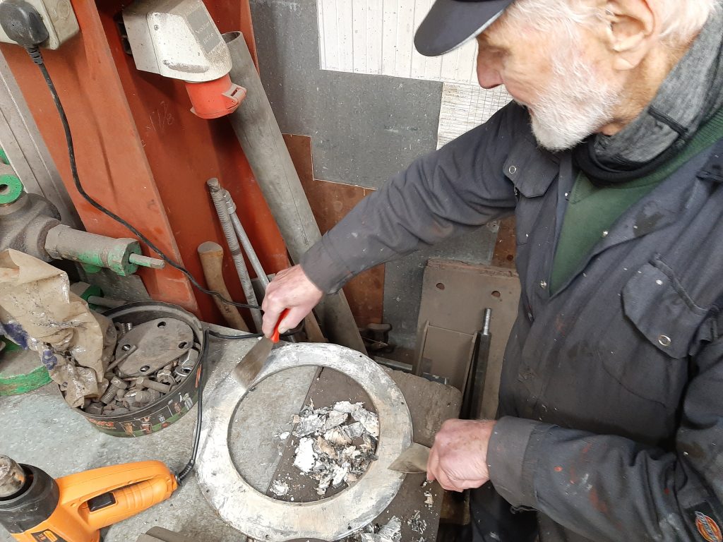 Roger cleaning the gas lamp housing rims