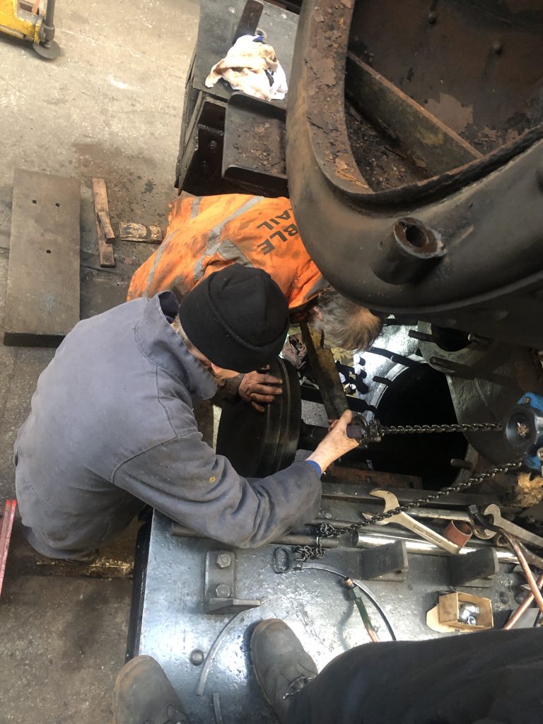 John Dixon coaxing a piston into position