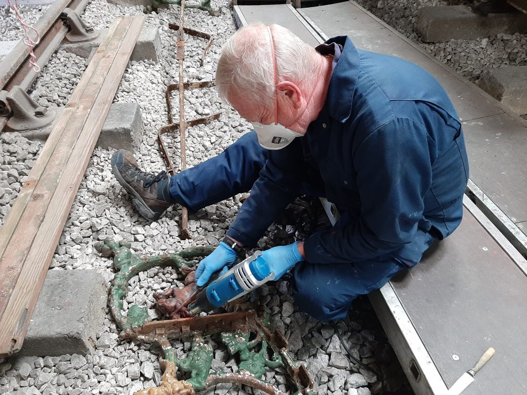 Paul Newton removing paint from the Furness Railway bench castings