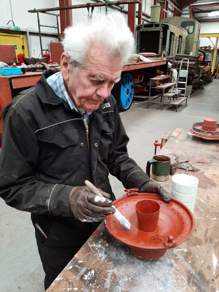 Fred painting a gas lamp housing lid for GER No. 5