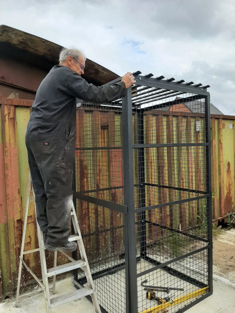 John Dixon makes the final adjustments to the cage