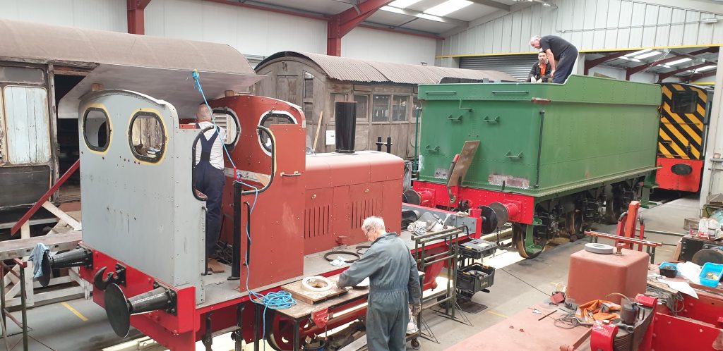 John Davis in Fluff's cab, John Dixon works on roof vents and Matt Crabtree and Keith are on Wootton Hall's tender.