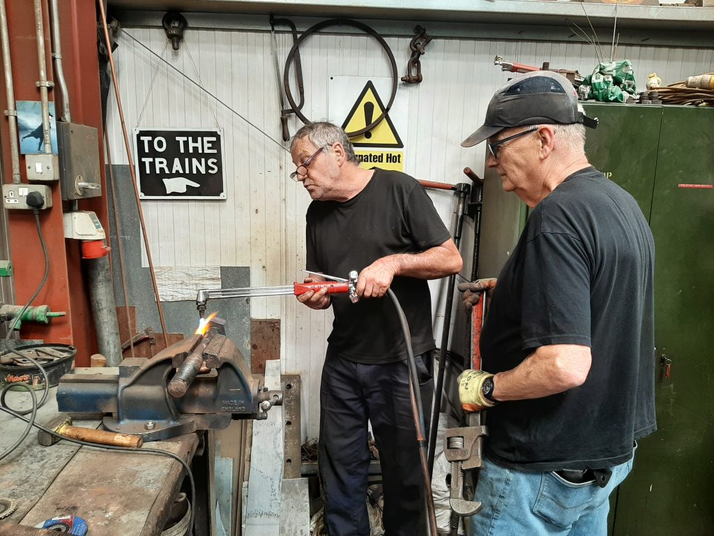 Keith and Ron removing a stubborn nut from one of Wootton Hall's spring hanger bolts