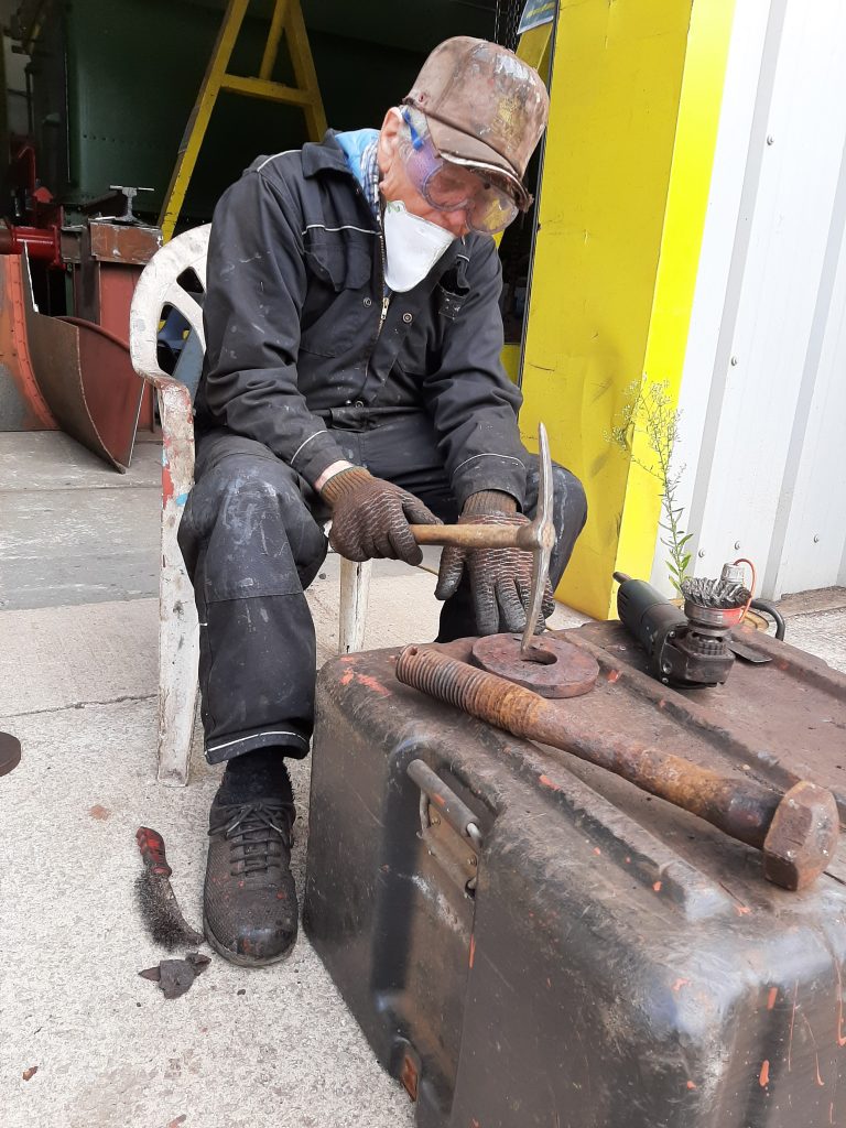 Fred chipping away at rust on spring hanger components for Wootton Hall
