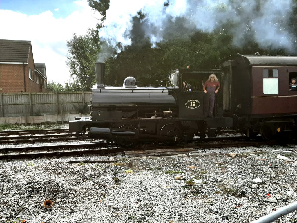 Ade leans out of No.19's cab as it heads away from Riverside station on Saturday, 10th September 2022