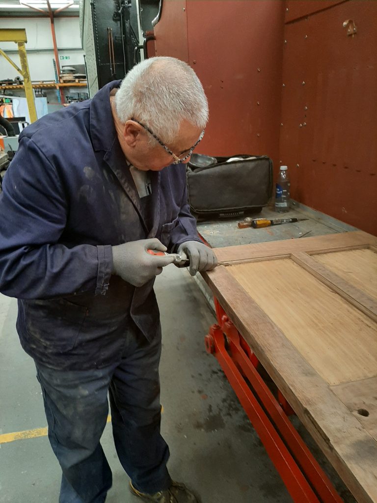 John Davis cleaning up one of the internal doors in GER 5