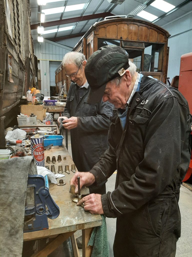 John Dixon and Fred cleaning door knobs and handles