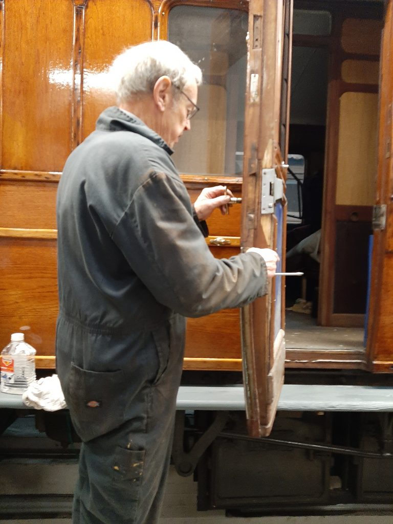 John Dixon re-fitting the door brasswork on GER 5