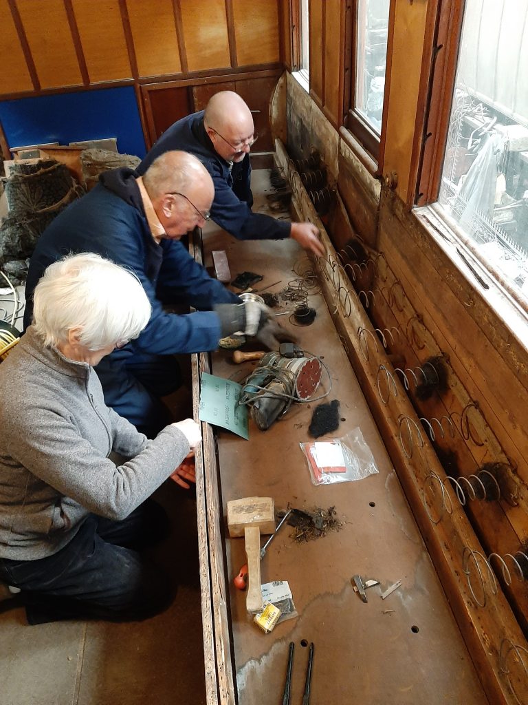 Ed Tatham, Phil Burton and David Starkie work on the chaise longue in GER No. 5