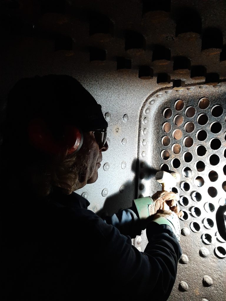 Ade works in Caliban's firebox to remove the remaining tubes