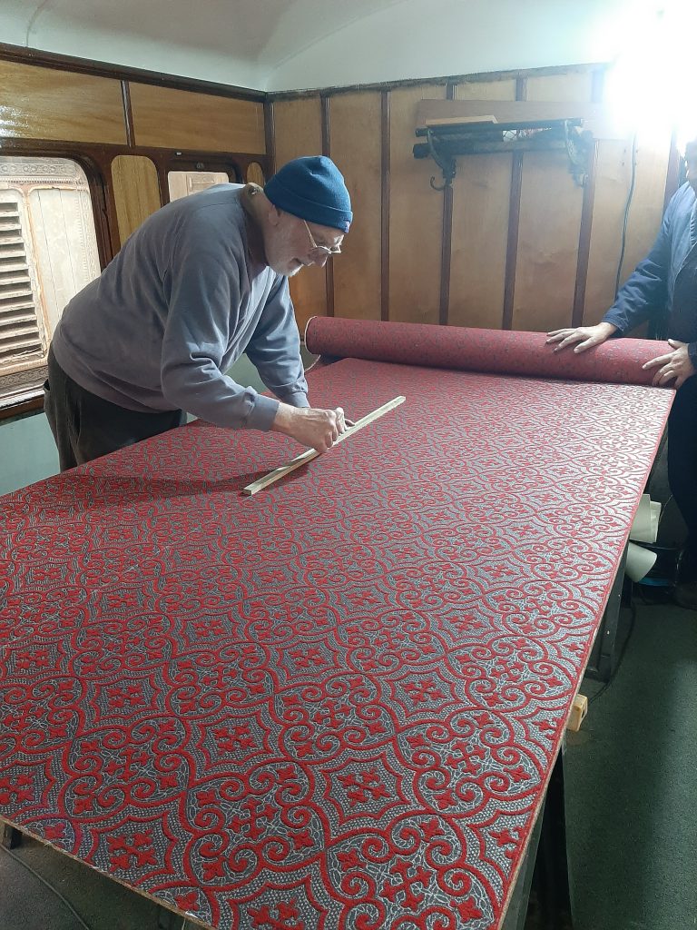 Phil Bell measuring the next piece of fabric to be fitted in GER 5