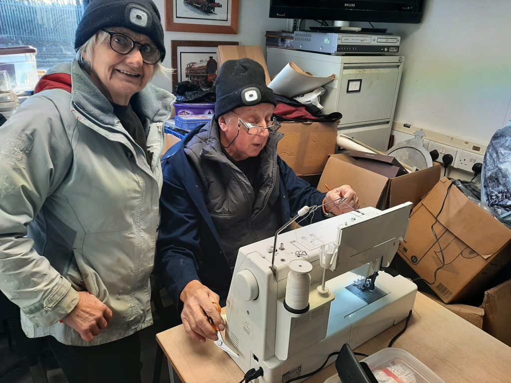 Anne and Phil Burton at work with the sewing machine