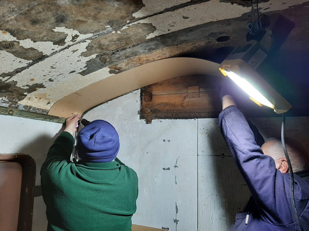Phil Bell and John Davis putting up the new ceiling in the kitchen compartment