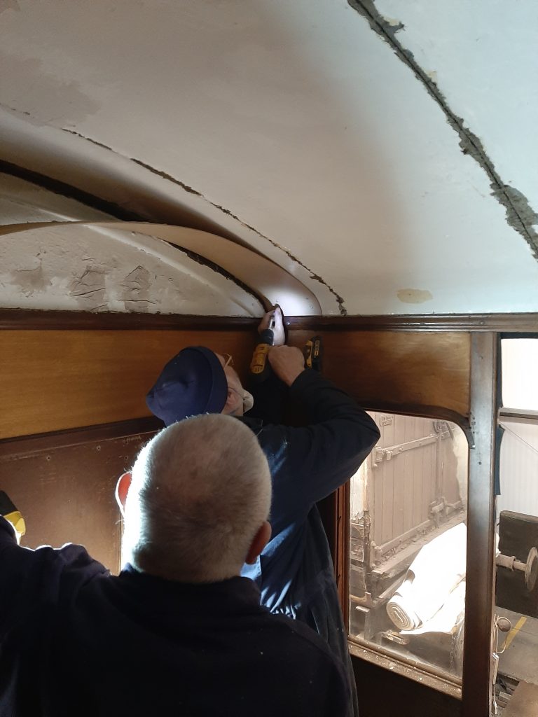 John Davis and Phil Bell fit a new ceiling in the guard's compartment of GER No. 5