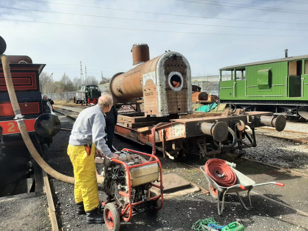 Neil Glover with the fire pump and Sam in the firebox