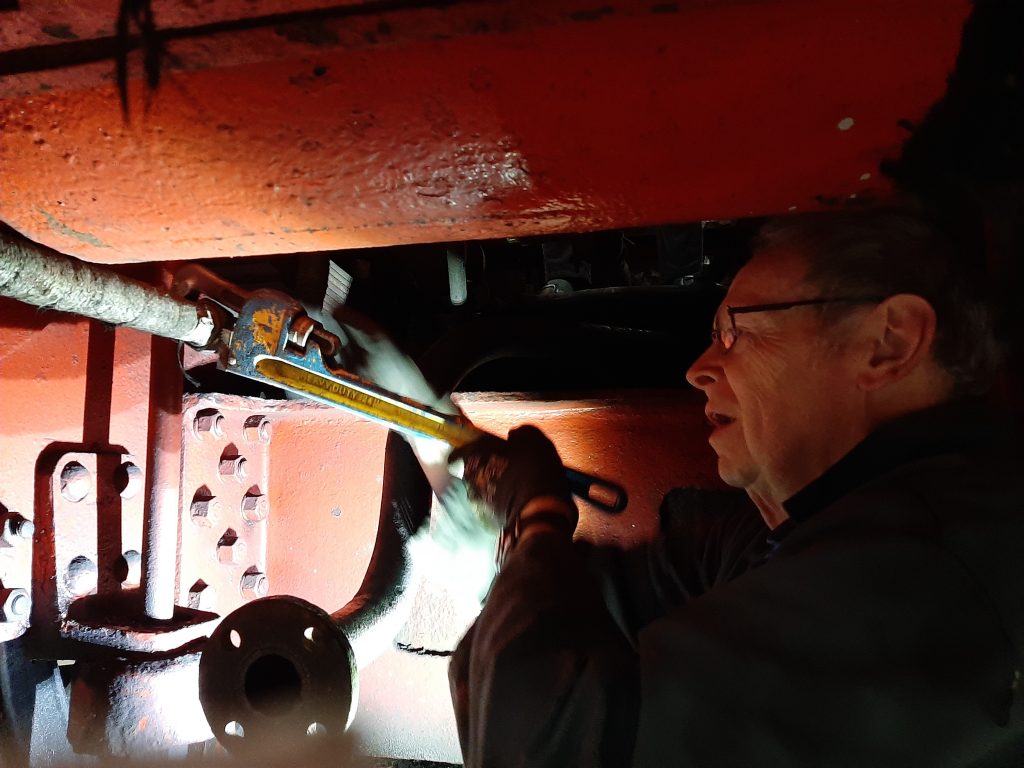 John Dixon at work with 5643's steam heating pipework