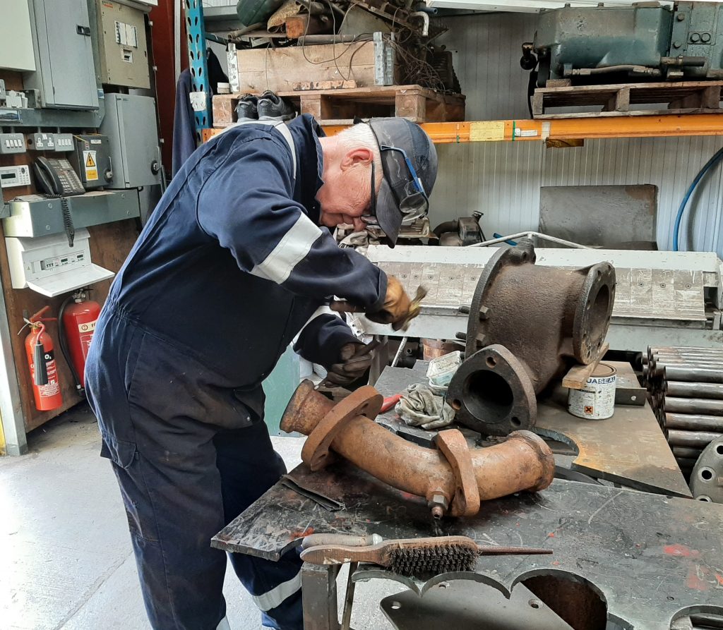 Ron Crowe cleaning one of 5643's steam pipes