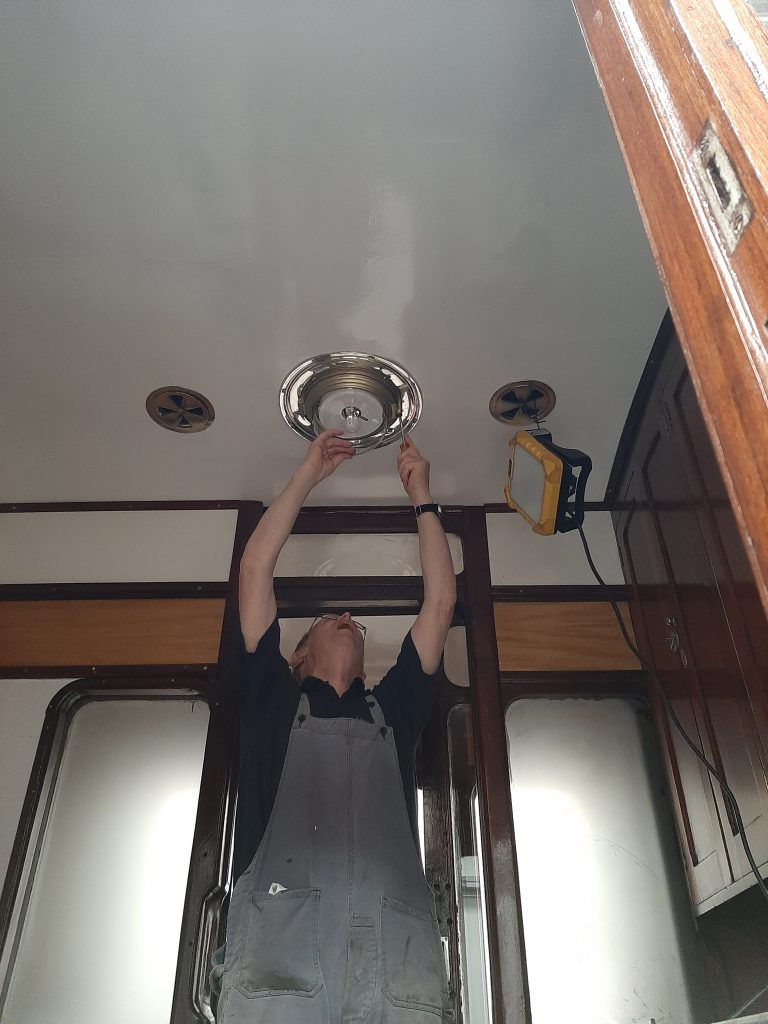 John Dixon fits one of the lights in GER No. 5