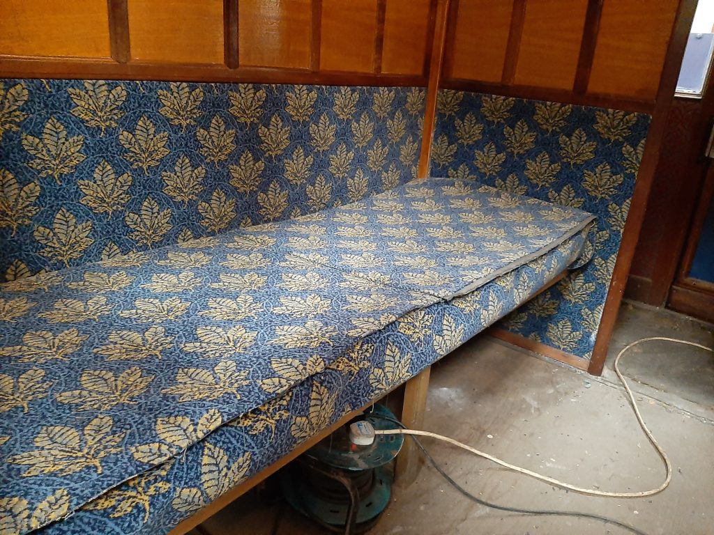 Upholstering of the new guard's compartment bench seat in progress