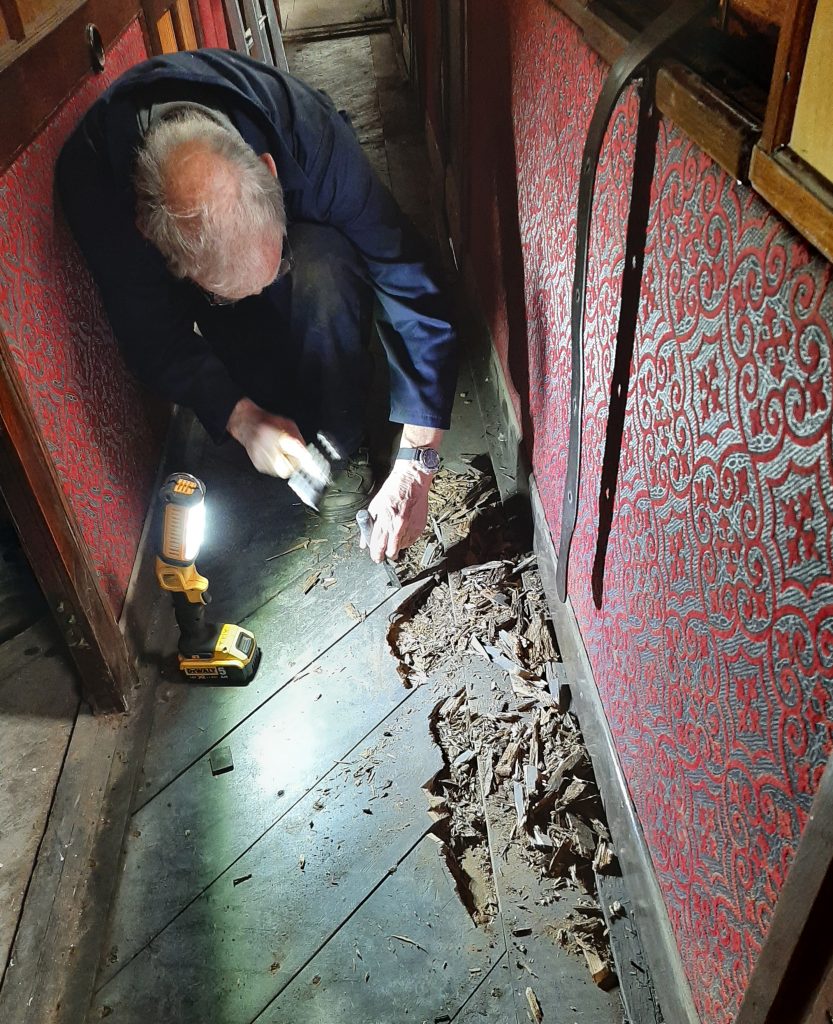 John Dixon cutting rot from GER No. 5's floor