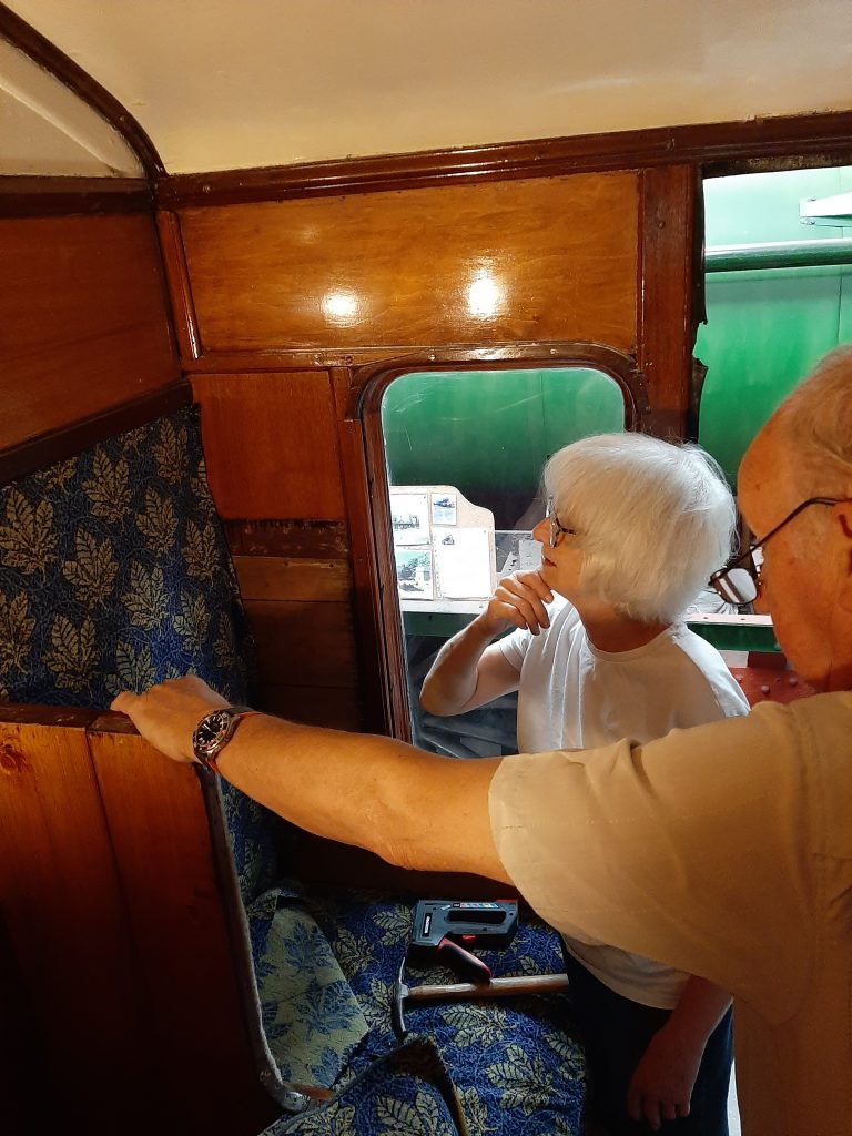 Anne and Phil Burton working on the upholstery in the guard's compartment of GER No. 5