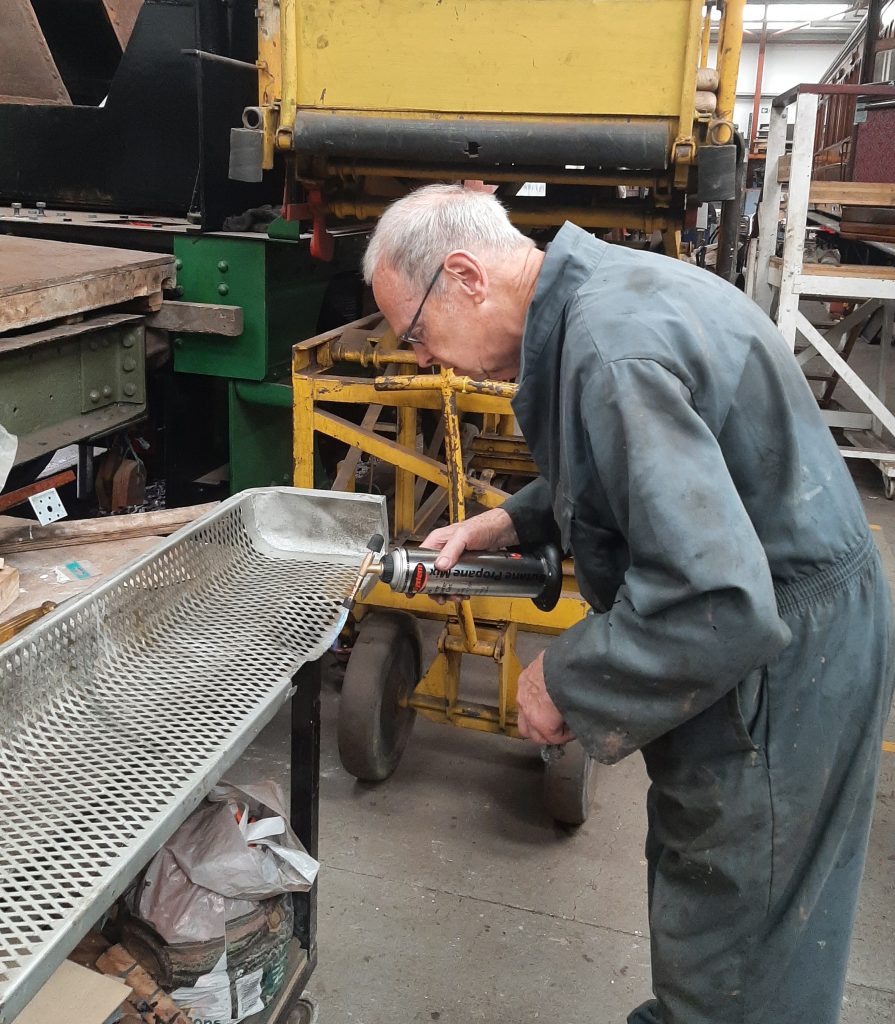 John Dixon repairing one of the radiator covers