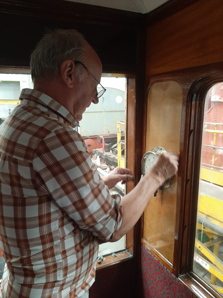 Phil Burton polishing GER No. 5's vacuum gauge.