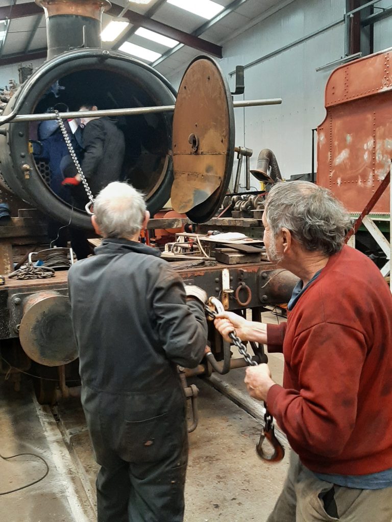 John Dixon and Keith Brewer lend a hand to haul out the flue tube
