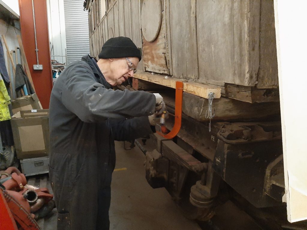 John Dixon paints one of the suction hose hangers