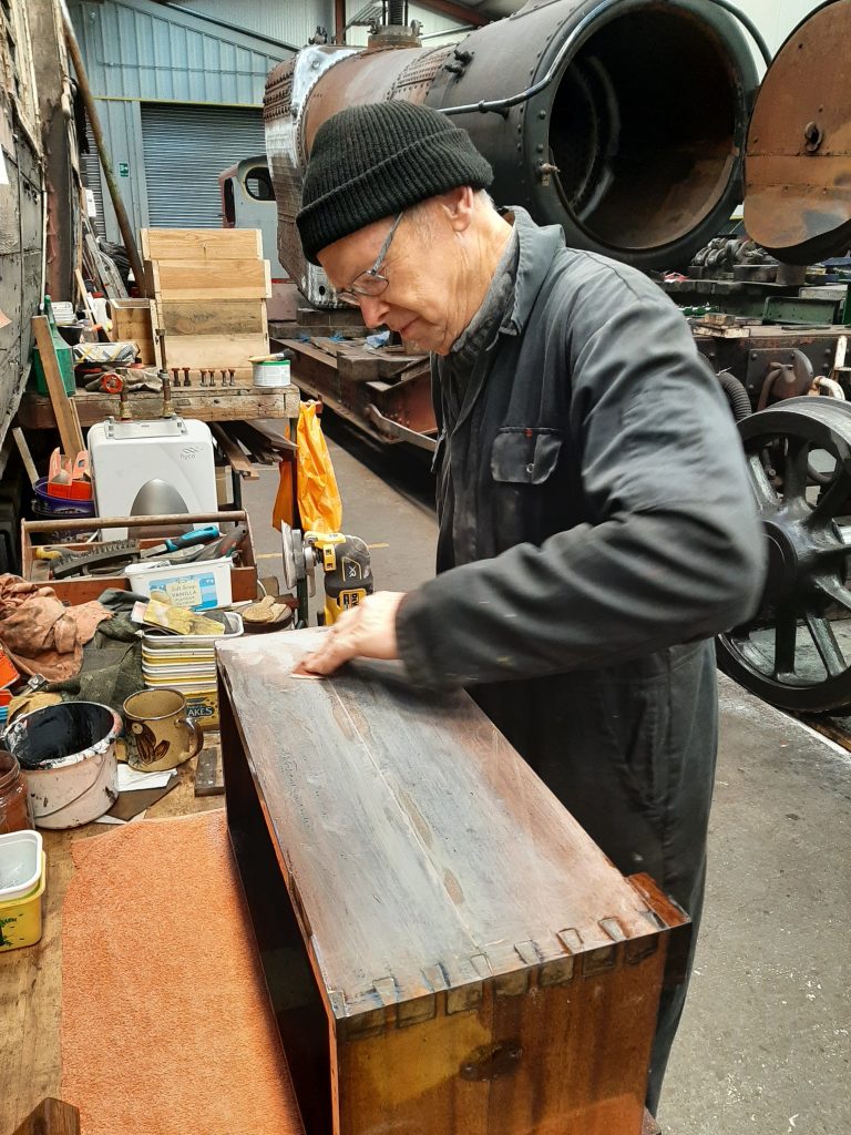 John Dixon attending to heat damage on FR20's wooden box