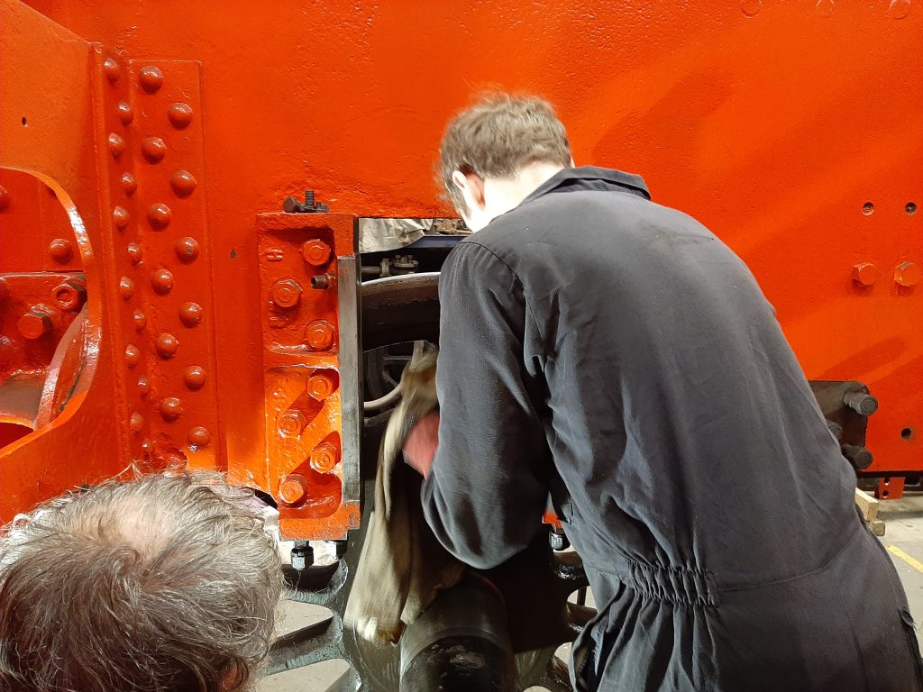 Sam cleaning the inside of one of 5643's wheels.