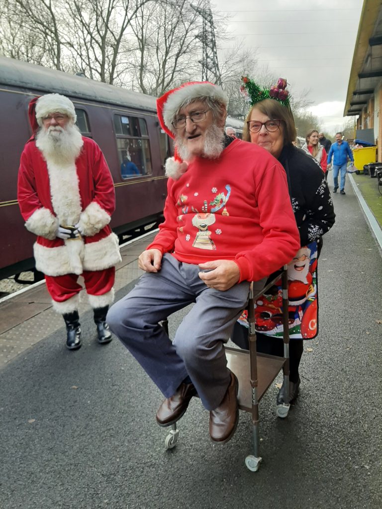 Alan is wheeled away from one of the Santa Specials by Alison