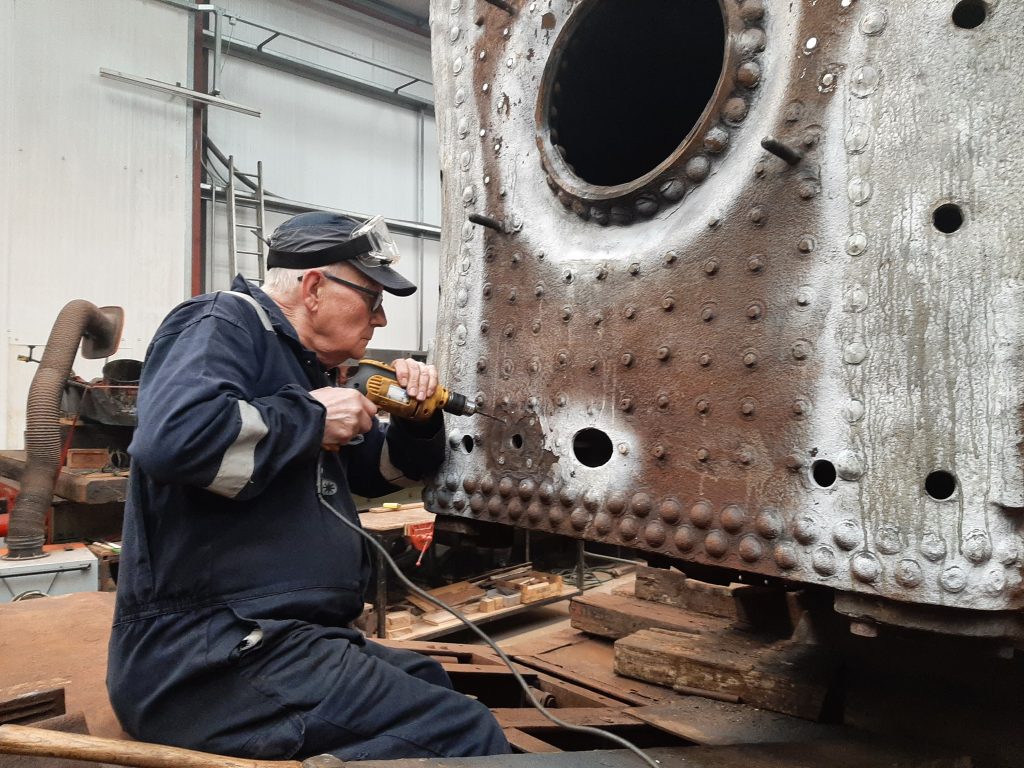 Ron Crowe drills out one of the firebox stays