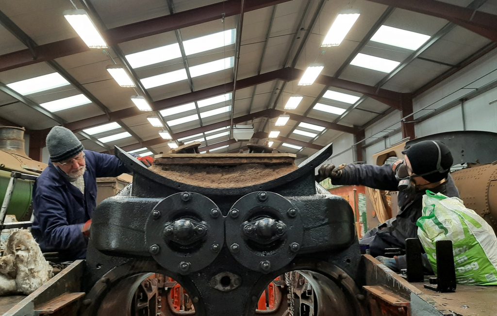 Sim and Jon Dixon applying high temperature black paint to 5643 steam chest and smokebox saddle