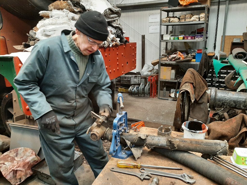 John Dixon cleans a brass steam heat coupling for GER 5