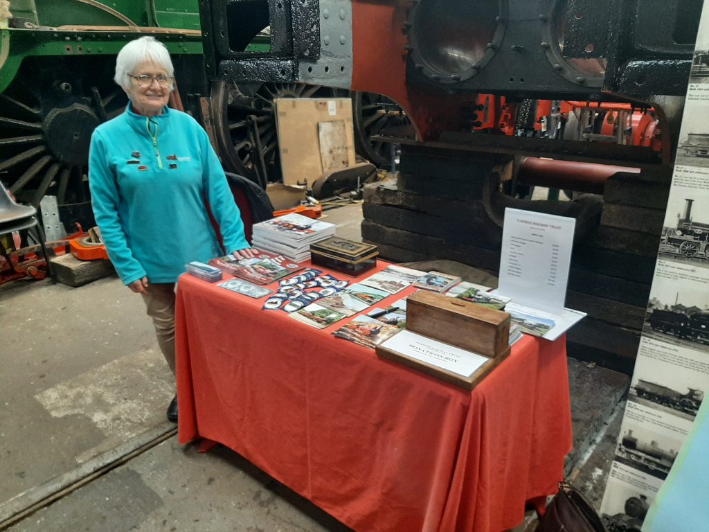 Anne Burton with the FRT's sales stand on Saturday during the RSR's spring Steam Gala.