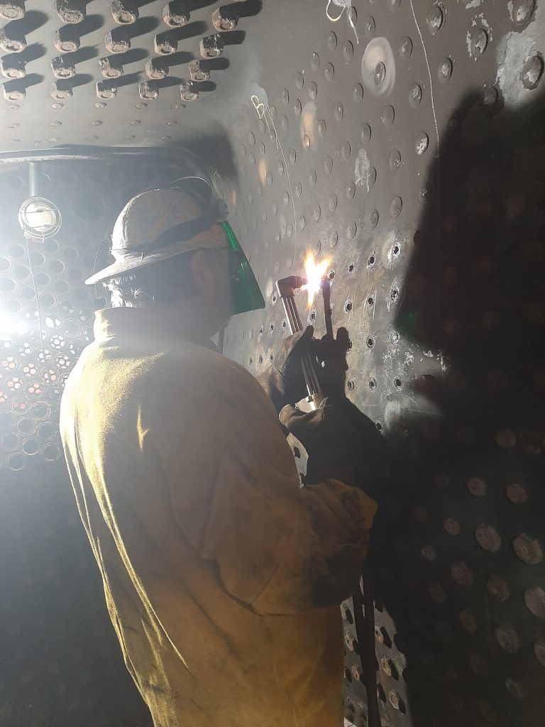 Keith using gas to cut out old stays from 5643's firebox